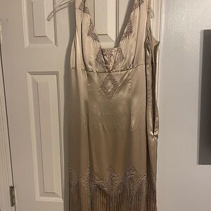 I have never worn it. New with tags. Sleek party dress with fringes